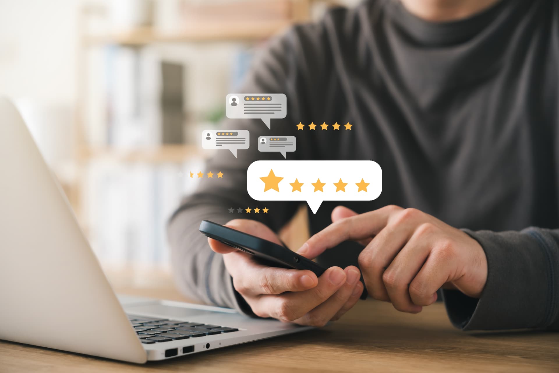 A person at a desk checking star ratings and reviews on a smartphone