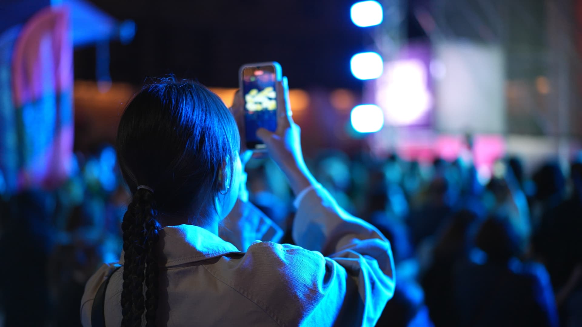 A crowd filming a live event on their phones